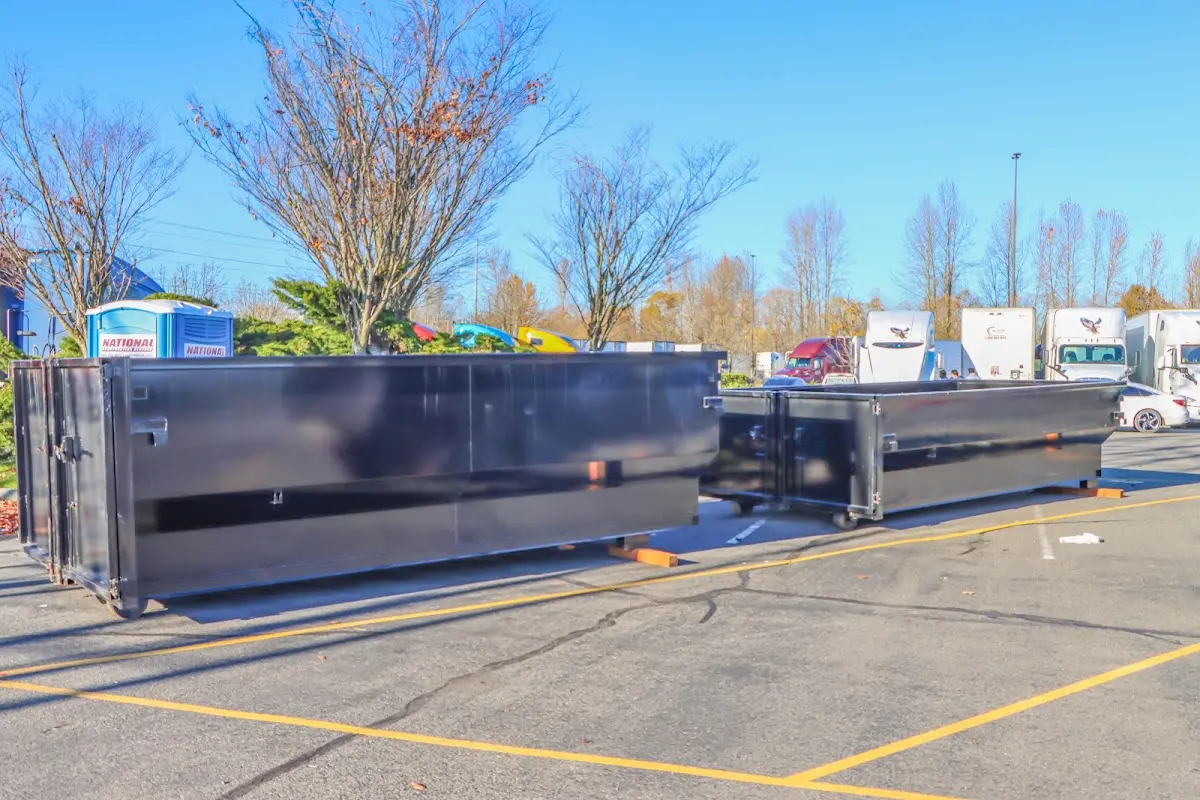 Professional dumpster rental service with roll-off container on residential driveway in Canal Fulton